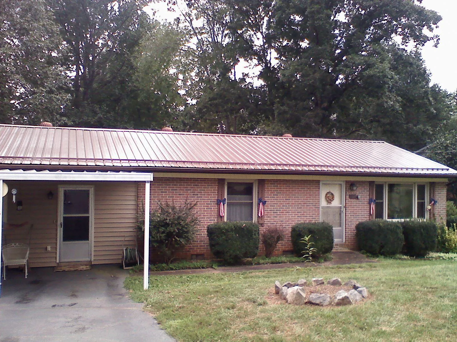 Bronze metal roof and carport on a brick ranch home — Roof Repair work by our crew in Carlsbad